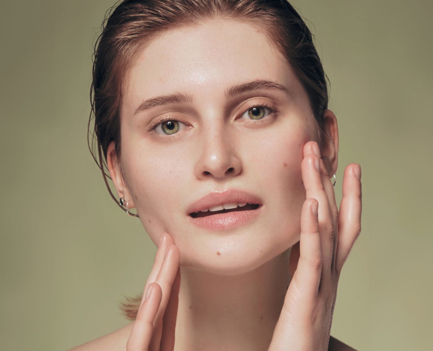 hydrafacial patient model touching her face