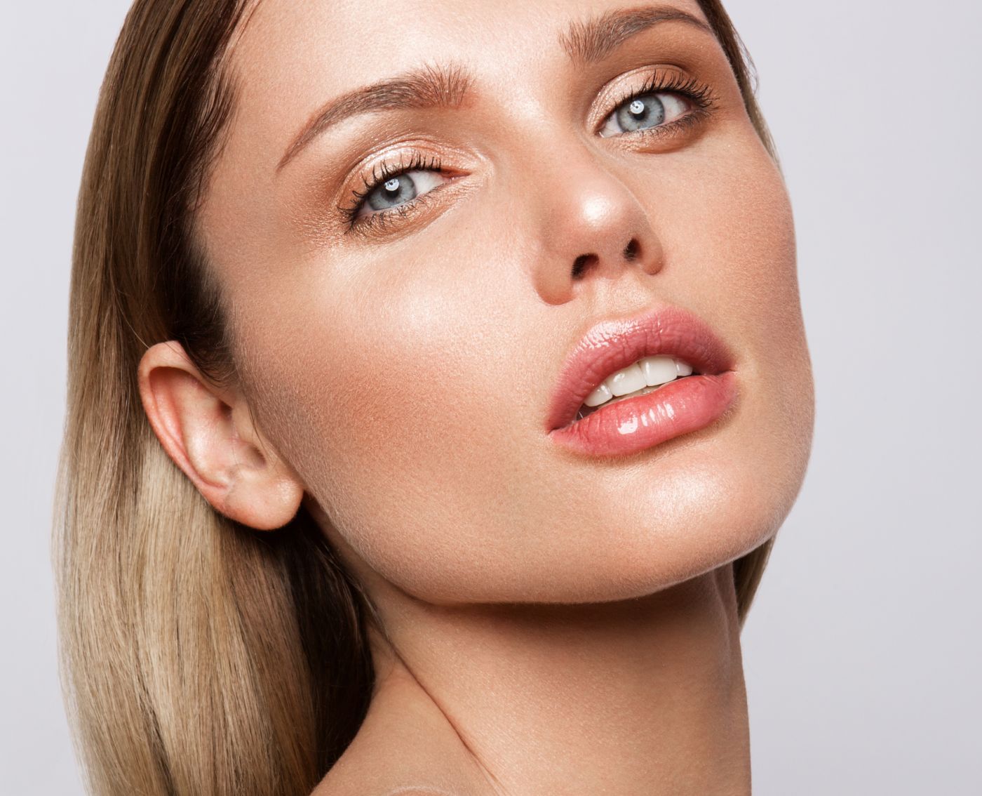 dermal filler patient model with blue eyes with her lips parted