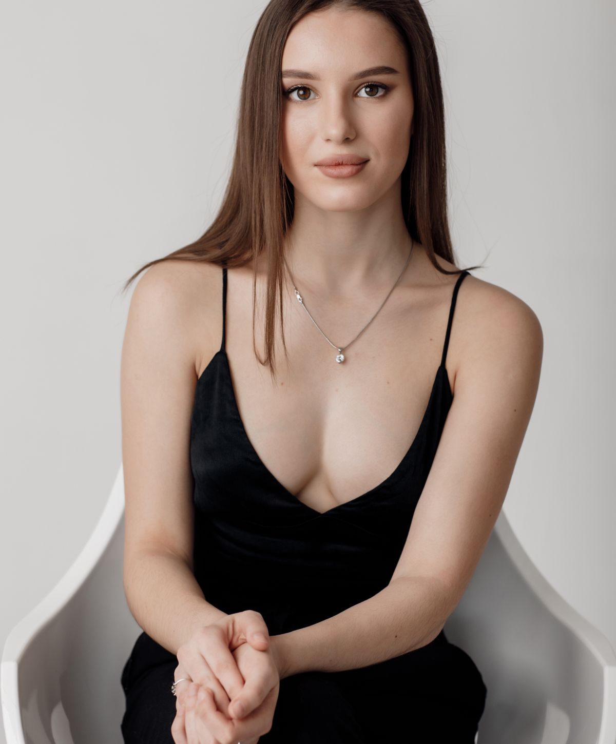 sculptra patient model in a low cut black dress