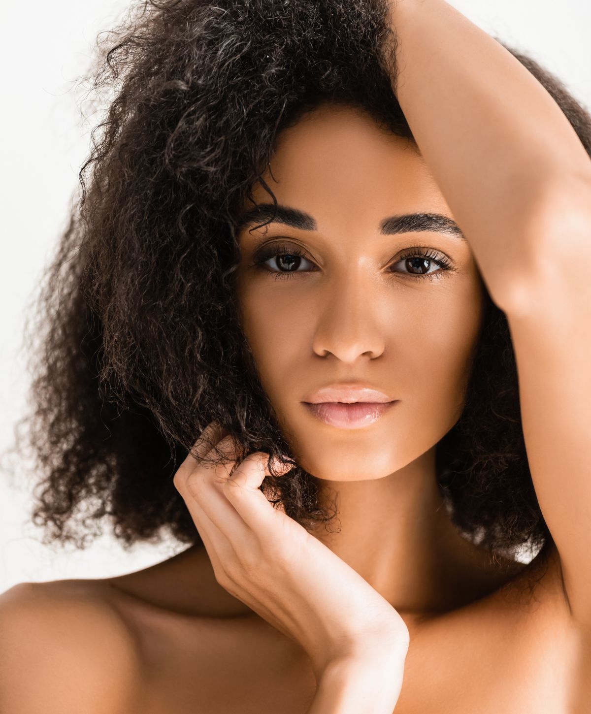 Portrait of a seattle kybella patient model with curly hair.