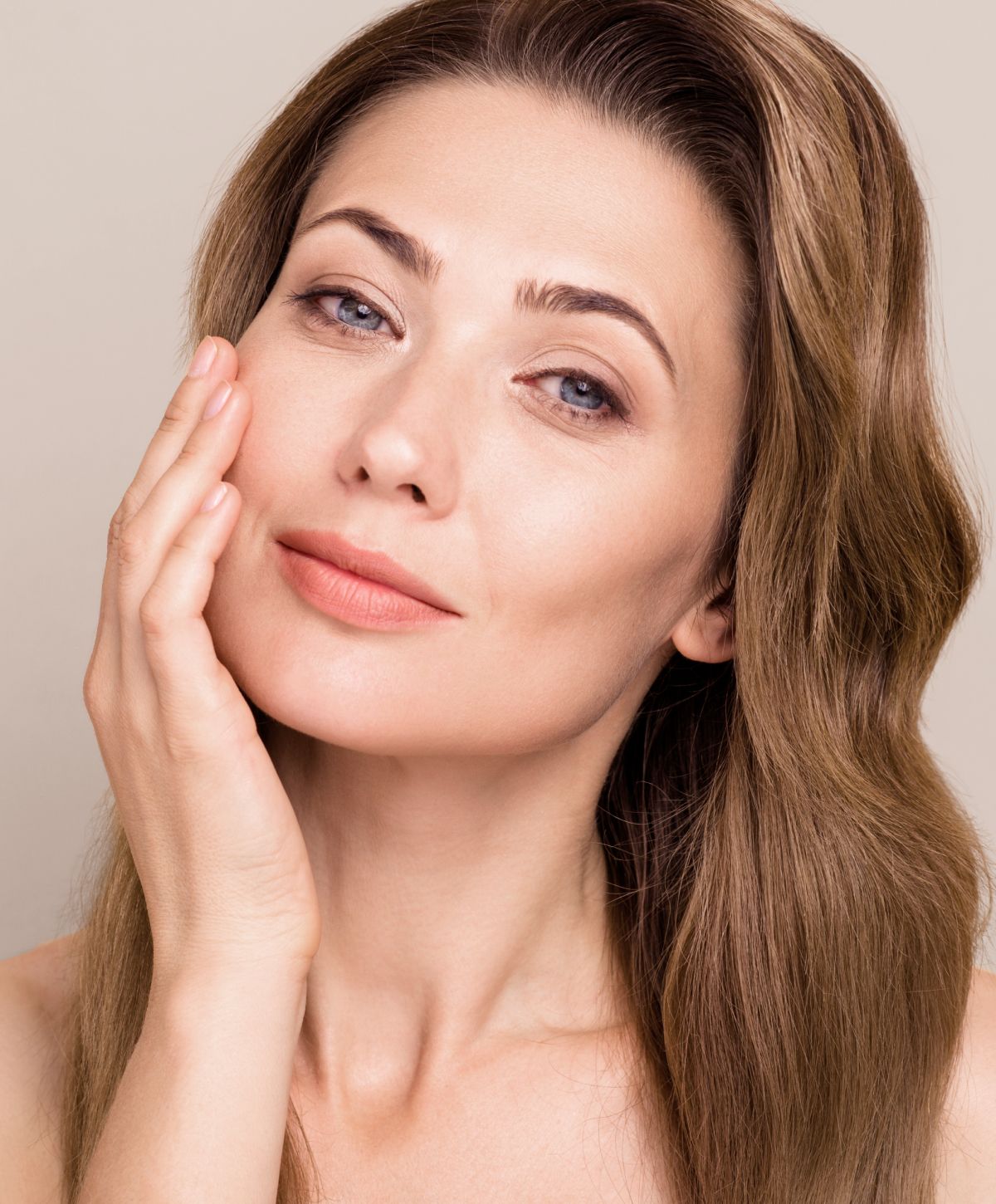 microneedling patient model smiling while touching her face