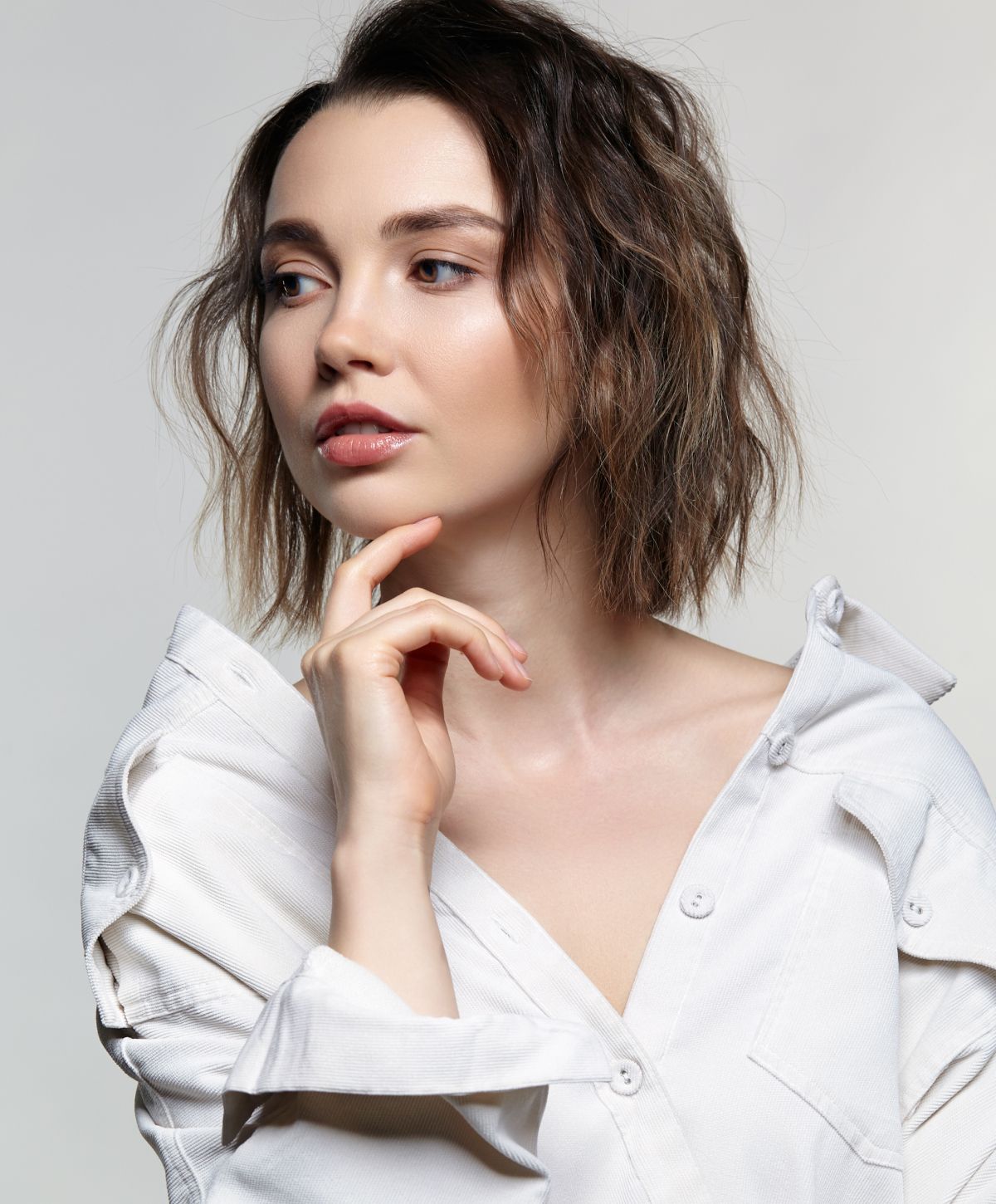 microneedling patient model with short hair in a white shirt.