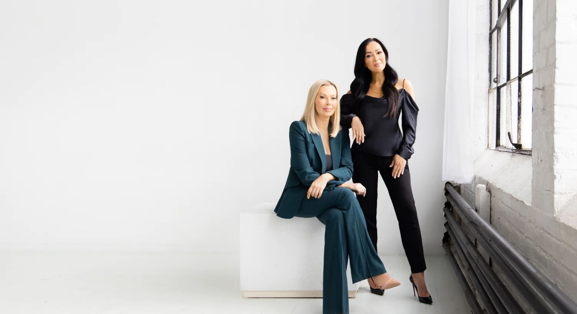 med spa owners sitting and standing in a white room