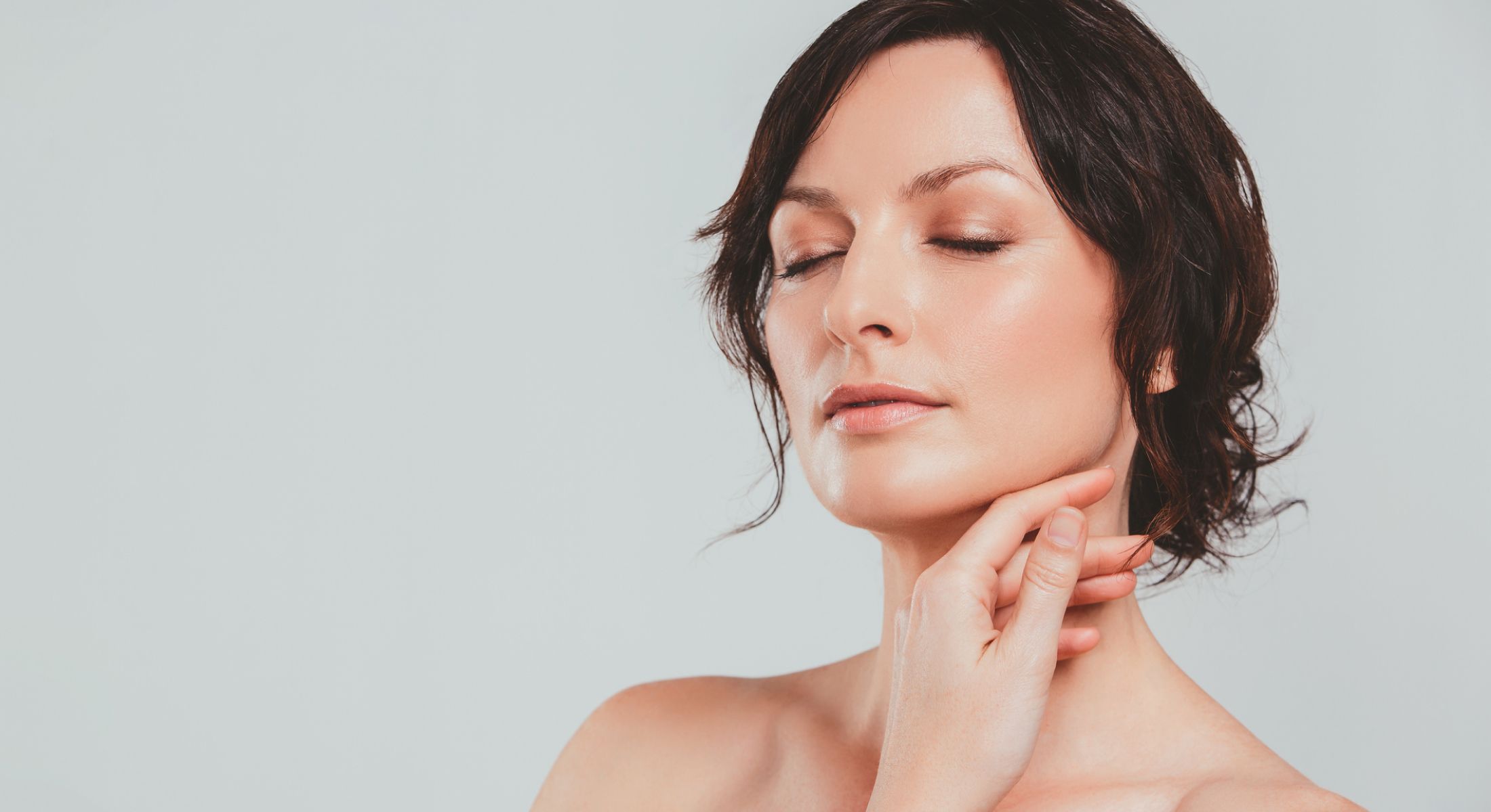 pdo thread lift patient model touching her chin with her eyes closed