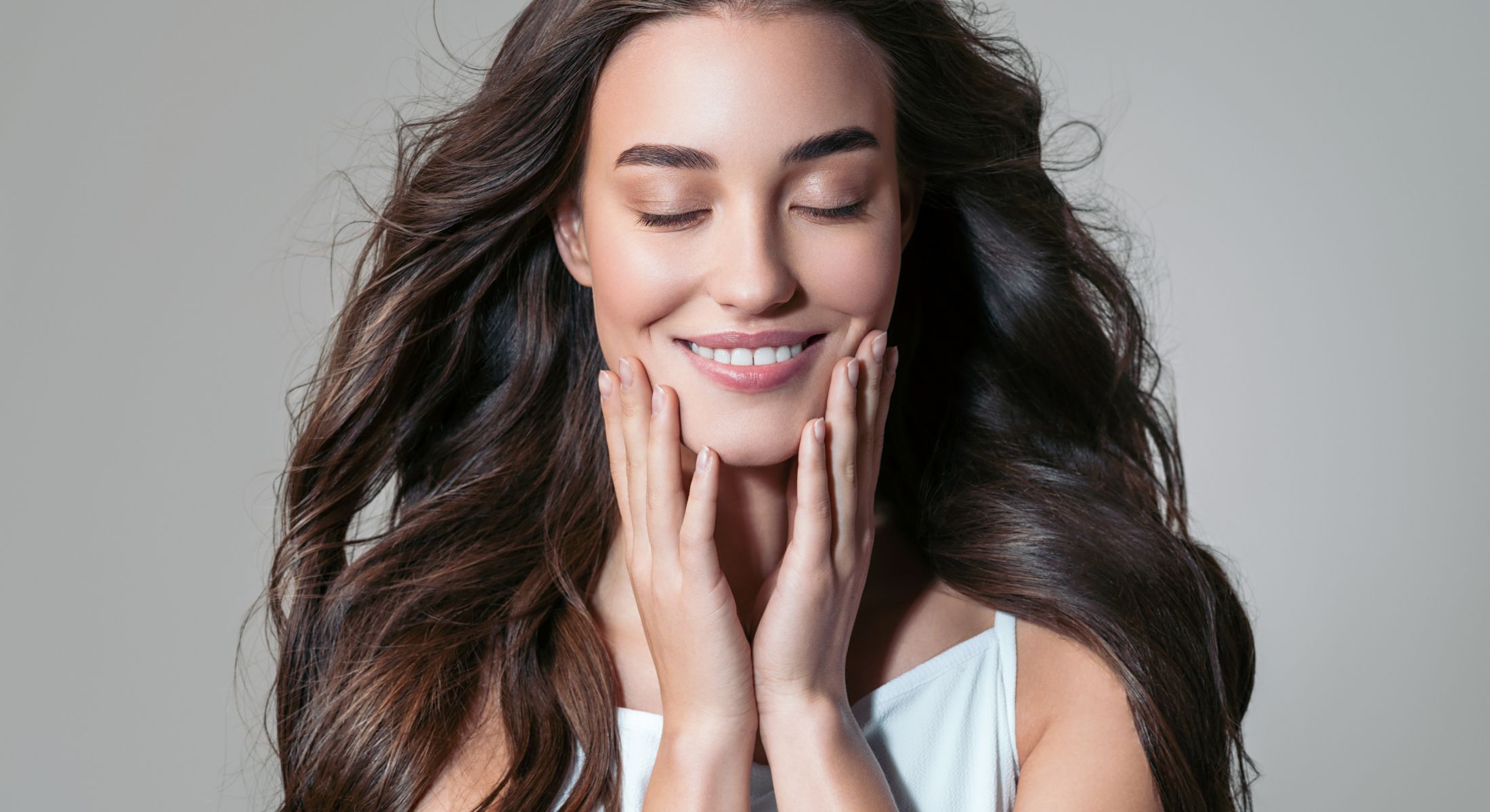 spectra hollywood peel patient model ina white top smiling with here eyes closed